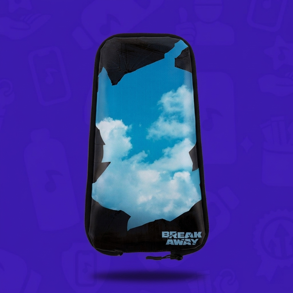 The (Official) Breakaway Skin zipped onto a black Lunchbox hydration pack, featuring a photorealistic blue sky and clouds visible through a black jagged "breakaway" frame, with the Breakaway Festival logo in the bottom corner.