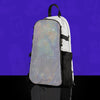 Reflective shimmering silver disco ball pattern skin on a white anti-theft hydration pack for festivals, shown on a studio purple background