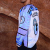 Side view of limited edition white and lavender Lunchbox festival hockey jersey featuring wave pattern sleeves and shoulder patches at Red Rocks.