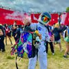 Person in astronaut costume with colorful backpack at a festival