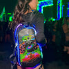 Festival attendee wearing a Lunchbox hydration pack with illuminated EL lightshow wire highlighting the EDC Orlando 2026 skin