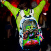 Festival attendee in a neon green mesh top wearing a illuminated Lunchbox hydration backpack with the EDC Orlando 2026 skin