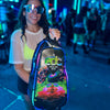 Festival attendee wearing sunglasses and holding up a Lunchbox hydration pack with the EDC Orlando 2026 skin