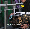 Festival attendee filling up a Lunchbox hydration pack with the EDC skin at a side water refill station