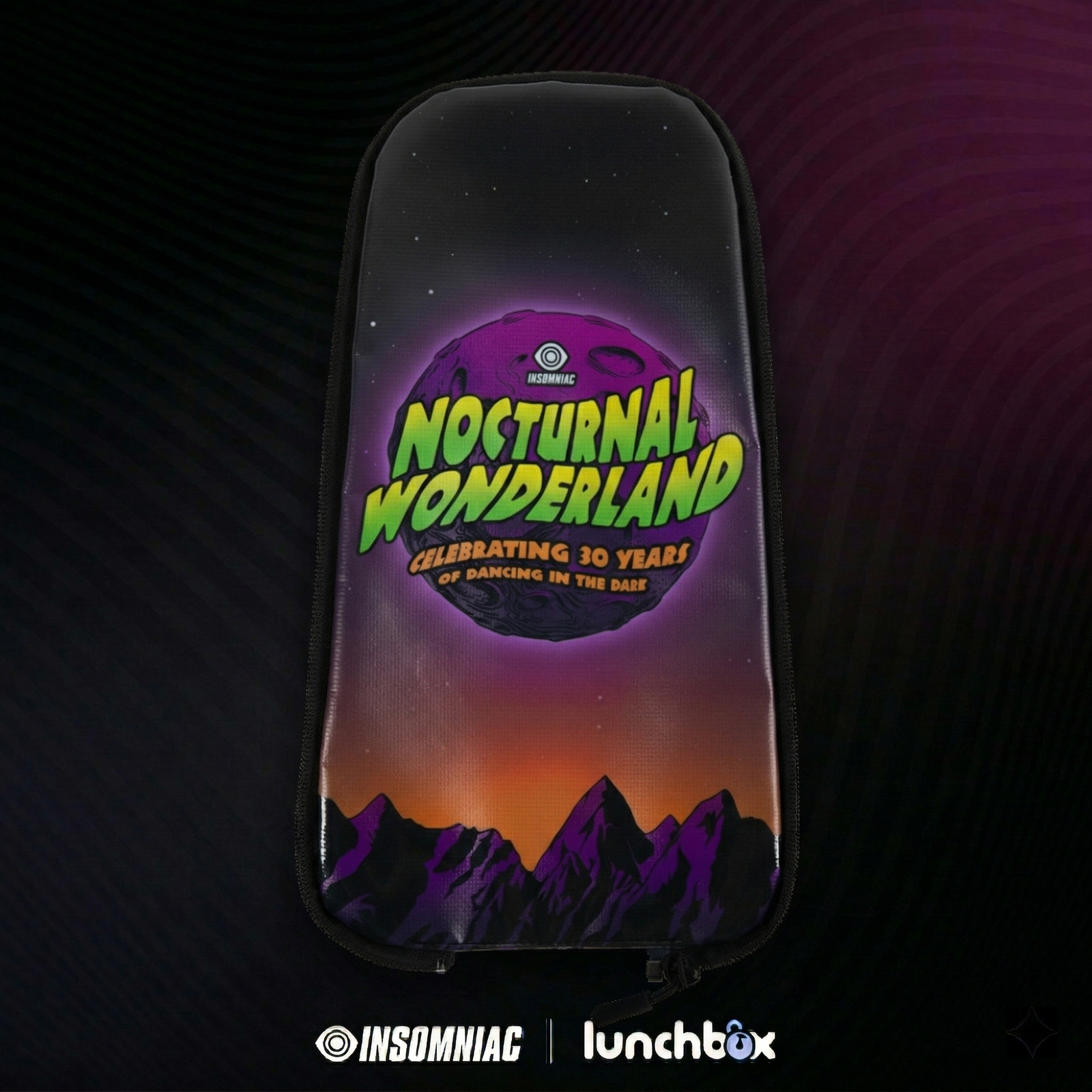 Nocturnal Wonderland 30th Anniversary hydration pack skin by Lunchbox, featuring a purple moon and mountain landscape design with 'Celebrating 30 Years of Dancing in the Dark' text.