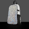 The holographic Prismatic Skin zipped onto a black Lunchbox hydration pack, featuring a silver cracked-ice texture that reflects rainbow colors on a gray background