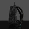 Side profile view of a black anti-theft festival hydration pack with adjustable mesh straps and a theft-proof zipper design on a gray background