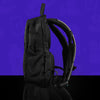 Profile view of the black anti-theft hydration pack by Lunchbox, featuring an all-black aesthetic with breathable mesh straps, displayed against a vibrant purple background