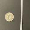 US quarter coin shown next to a thin Cosmic LED Strip segment for size reference
