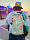 Rear view of person wearing a white Lollapalooza 2026 hydration pack with colorful Chicago line art at a festival