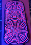 A custom-designed Black DIY Skin for a Lunchbox hydration pack, featuring a hand-painted psychedelic pattern of concentric, wavy flower-like shapes in vibrant pink and purple against a dark background.